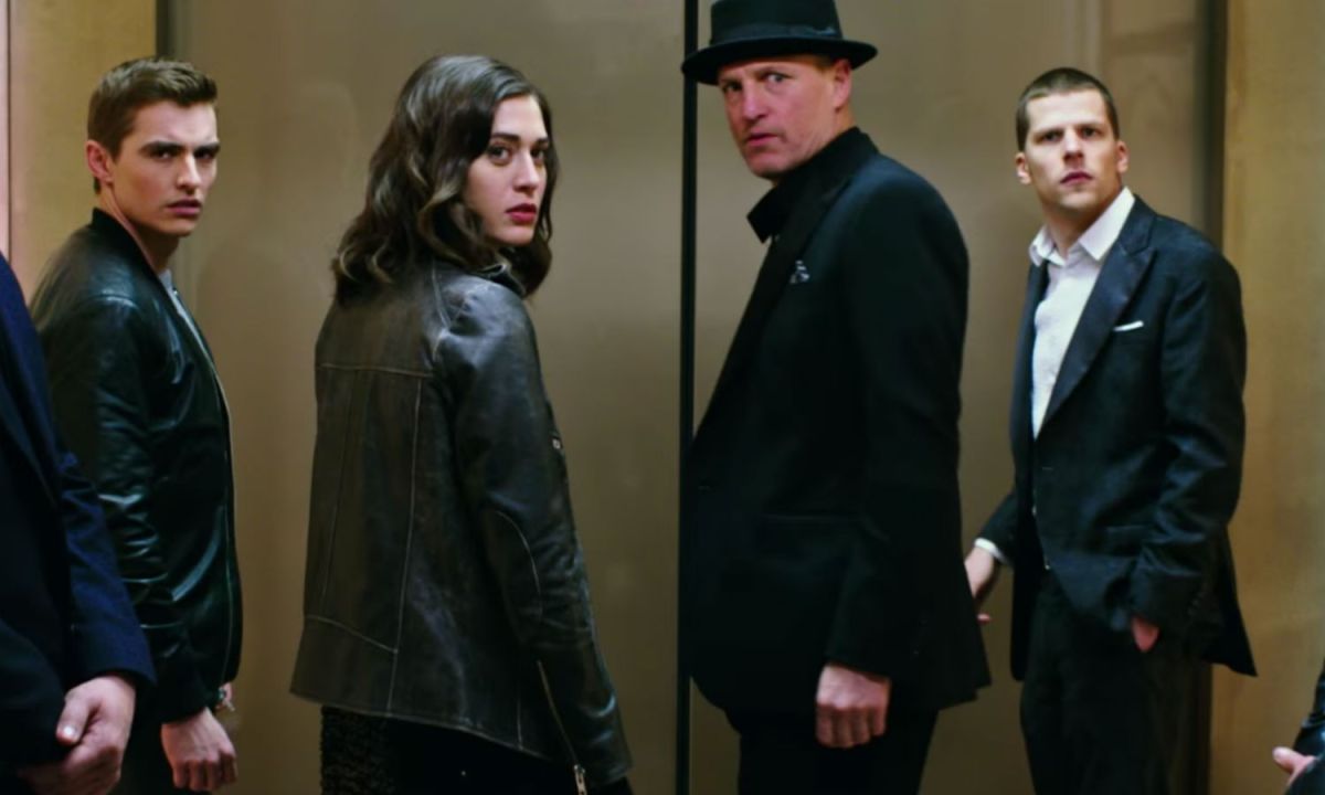A group of four people stand in an elevator in Now You See Me 2.